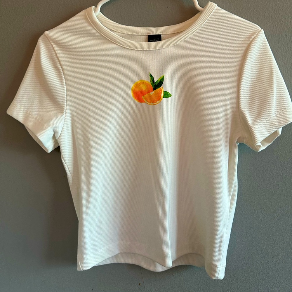 White cropped shirt with orange on it